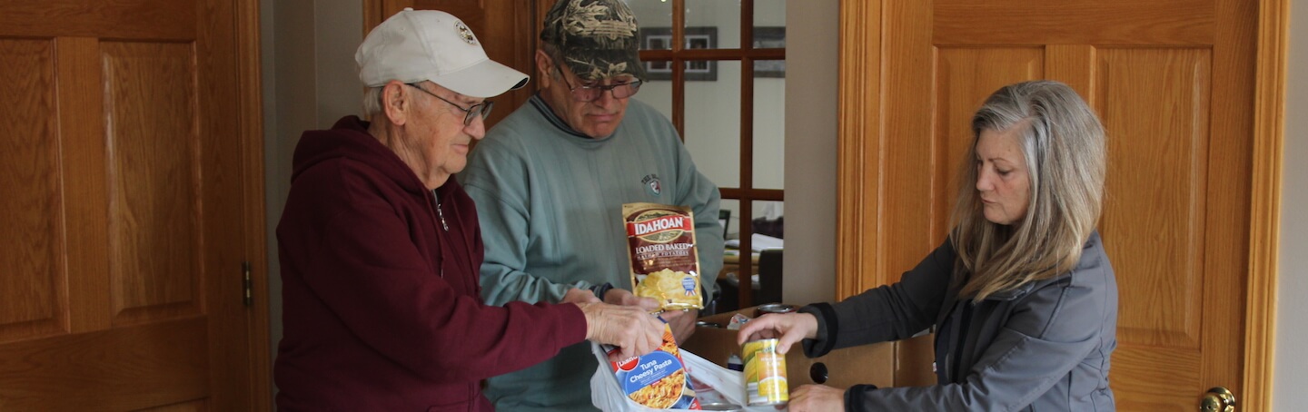 Volunteers packing bags of food